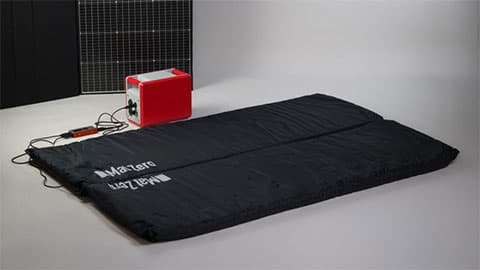 Mat Zero mat showing that it can be powered by solar or battery, or even by plug. The mat is in the foreground and the background is plain white.